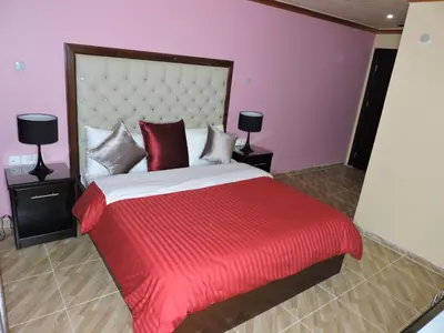 a bedroom with a large bed with a red blanket at Valentine Inn Luxury in Wadi Musa