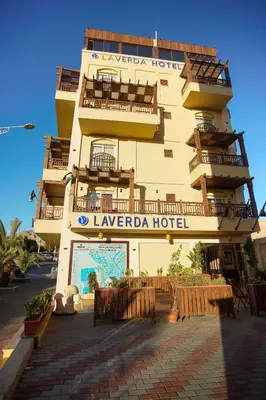a building with a hotel sign in front of it at Laverda Hotel in Aqaba