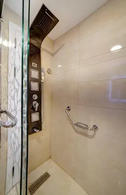 a bathroom with a shower with a glass door at Laverda Hotel in Aqaba