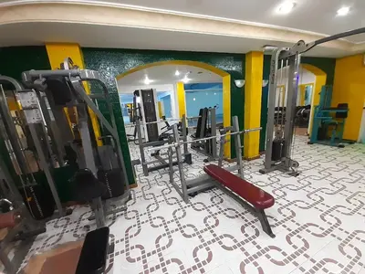 a gym with rows of treadmills and machines at Amman Ambiance Hotel in Amman