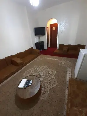 a living room with a couch and a coffee table at Amman Ambiance Hotel in Amman