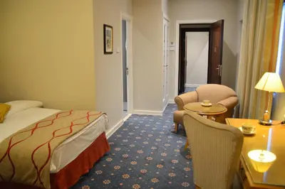 a hotel room with a bed and a table and chairs at The Y Hotel in Amman