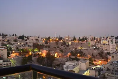 a view of a city at night at The Y Hotel in Amman