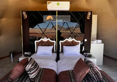a bedroom with two twin beds with pillows at Wadi Rum Desert Adventures in Wadi Rum
