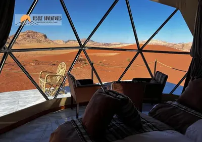 a room with chairs and a view of the desert at Wadi Rum Desert Adventures in Wadi Rum