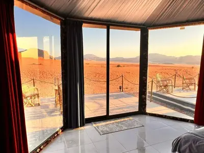 a room with a view of the desert through the window at Wadi Rum Desert Adventures in Wadi Rum