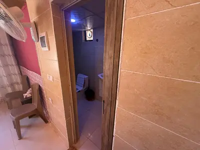 a small bathroom with a shower and a toilet at Myra Stars Camp & Tours in Wadi Rum