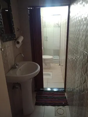 a bathroom with a sink and a toilet at Wateen Home in Wadi Musa