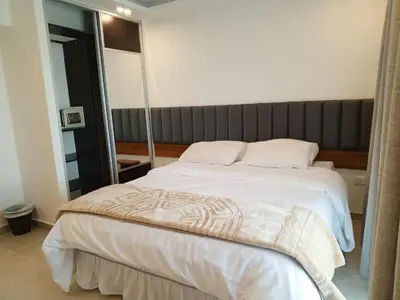 a bedroom with a large white bed in a room at Sedrah Hotel in Irbid