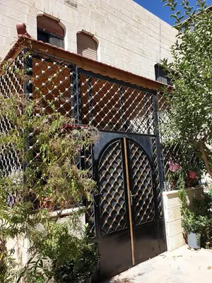 an iron gate in the side of a building at PALM Home in Amman