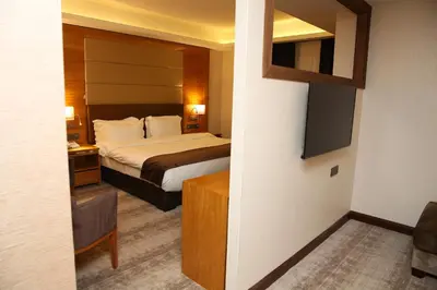 a bedroom with a bed in a hotel room at Gloria Hotel Amman in Amman
