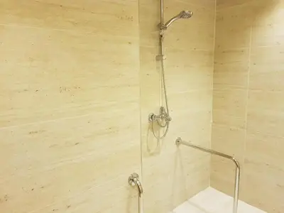 a shower with a glass door in a bathroom at Gloria Hotel Amman in Amman