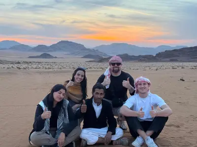 a group of people giving thumbs up in the desert at Wadi rum Bedouin Experience in Wadi Rum