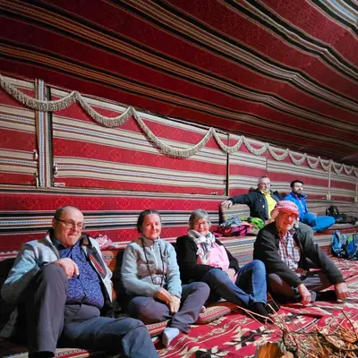 a group of people sitting in a tent at Candle light camp & tours in Wadi Rum