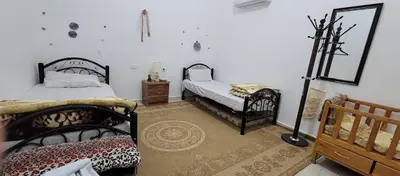 a bedroom with two beds and a mirror at Idris home in Wadi Musa