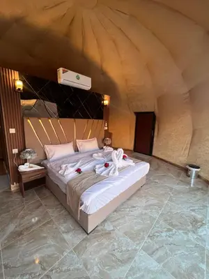 a bedroom with a bed in a tent at Sand Star Camp in Wadi Rum