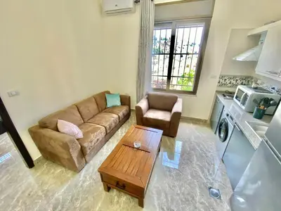 a living room with a couch and a coffee table at Villa Mira Guesthouse 1 - Downtown Central Amman - AL DIYRIH in Amman