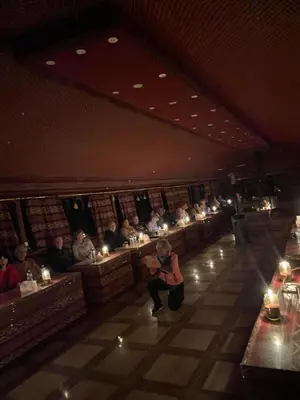 a group of people sitting in a room with candles at Desert shine camp in Wadi Rum