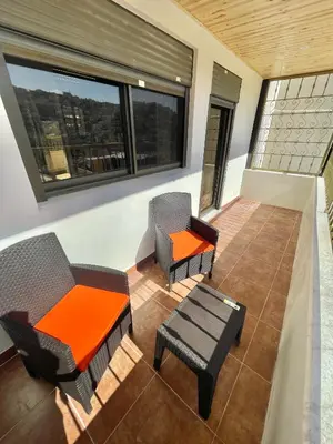 a room with chairs and a table and a window at Villa Mira GuestHouse 2 - Downtown Central Amman - AL DIYRIH in Amman