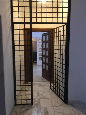 an entrance to a room with a mirror and a door at Nice Furnished apartment in Amman