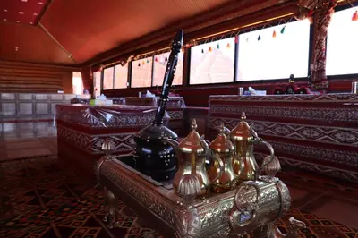 a temple with a group of bells in a room at Desert Bedouin camp in Wadi Rum