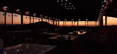 a dark room with tables and a train at sunset at Desert Bedouin camp in Wadi Rum