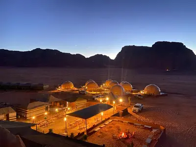 a group of domes in the desert at night at Faisal Wadi Rum Camp in Wadi Rum