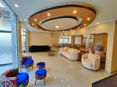 a lobby with a large room with couches and chairs at Rakan ApartHotel and Luxury Rooms in Wadi Musa