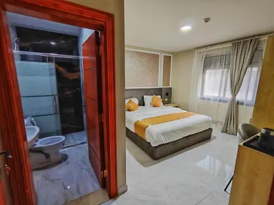a hotel room with a bed and a bathroom at Rakan ApartHotel and Luxury Rooms in Wadi Musa