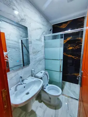 a bathroom with a sink and a toilet and a shower at Rakan ApartHotel and Luxury Rooms in Wadi Musa