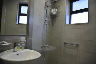 a bathroom with a sink and a shower at سما عمان للشقق الفندقية Sama Amman Hotel Apartments in Amman