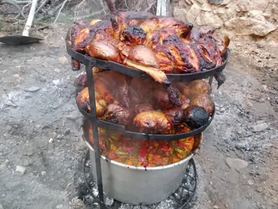 a bunch of chickens and other animals cooking on a grill at Petra Monastery Tourist Hotel in Wadi Musa
