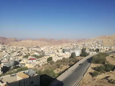 a view of a city with a road and buildings at Petra Monastery Tourist Hotel in Wadi Musa