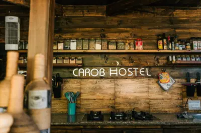 a wooden wall with a sign that reads cabo hostel at Carob Hostel in Amman