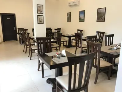 a row of tables and chairs in a restaurant at Petra Heart Hotel in Wadi Musa