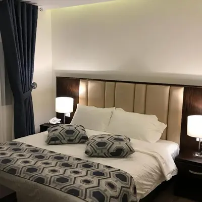 a bedroom with a bed with two pillows on it at Petra Heart Hotel in Wadi Musa