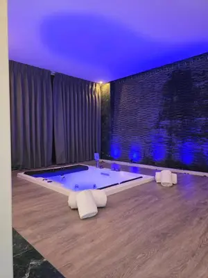 a jacuzzi tub in a room with blue lights at Opal Hotel Amman in Amman
