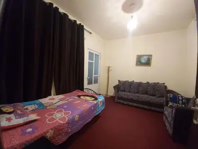 a living room with a bed and a couch at Jarajreh Apartments/ Hotel in Kerak
