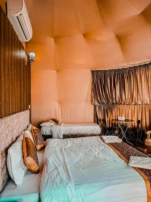 a bedroom with two beds and a window at Rum warm bubble camp in Wadi Rum