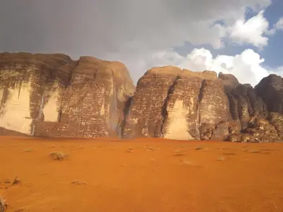 a large rock formation in the desert with a sky at Wadi rum desert breath in Wadi Rum