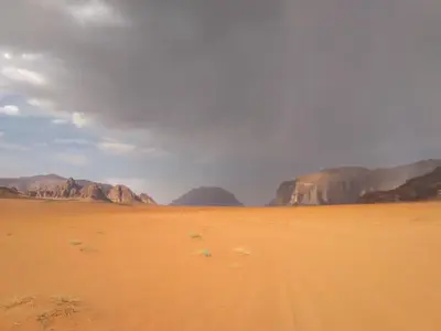 a view of a desert with mountains in the background at Wadi rum desert breath in Wadi Rum