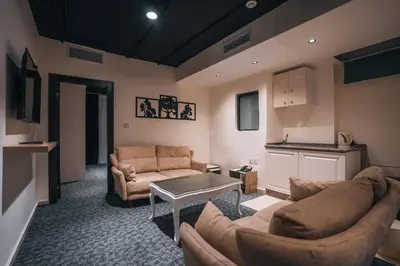 a living room with two couches and a table at Diamond Hotel in Amman