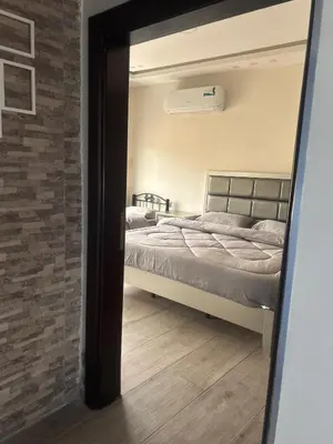a reflection of a bedroom with a bed in a mirror at The Pearl of Jerash in Jerash