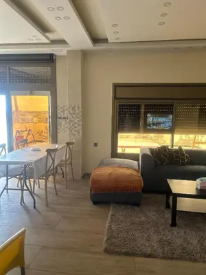 a living room with a couch and a table at The Pearl of Jerash in Jerash