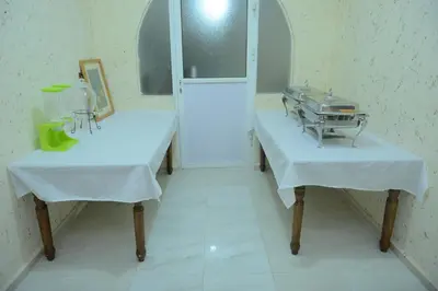a room with two tables in a hospital room at Petra Lion Hotel in Wadi Musa