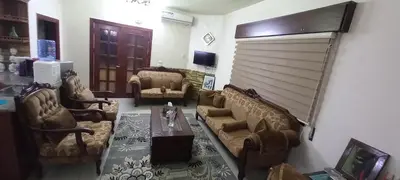 a living room with couches and a table at Jasmine's House in Jerash