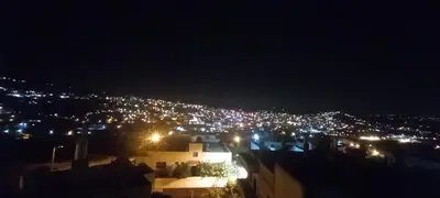 a view of a city at night with lights at Jasmine's House in Jerash