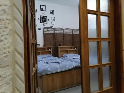 a small room with a bed and a window at Jasmine's House in Jerash