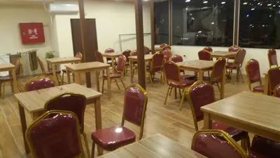 an empty restaurant with tables and chairs in a room at PETRA Cabin Dorms Hostel in Wadi Musa