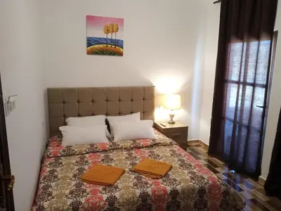 a bedroom with a bed with two towels on it at Petra Planet in Wadi Musa